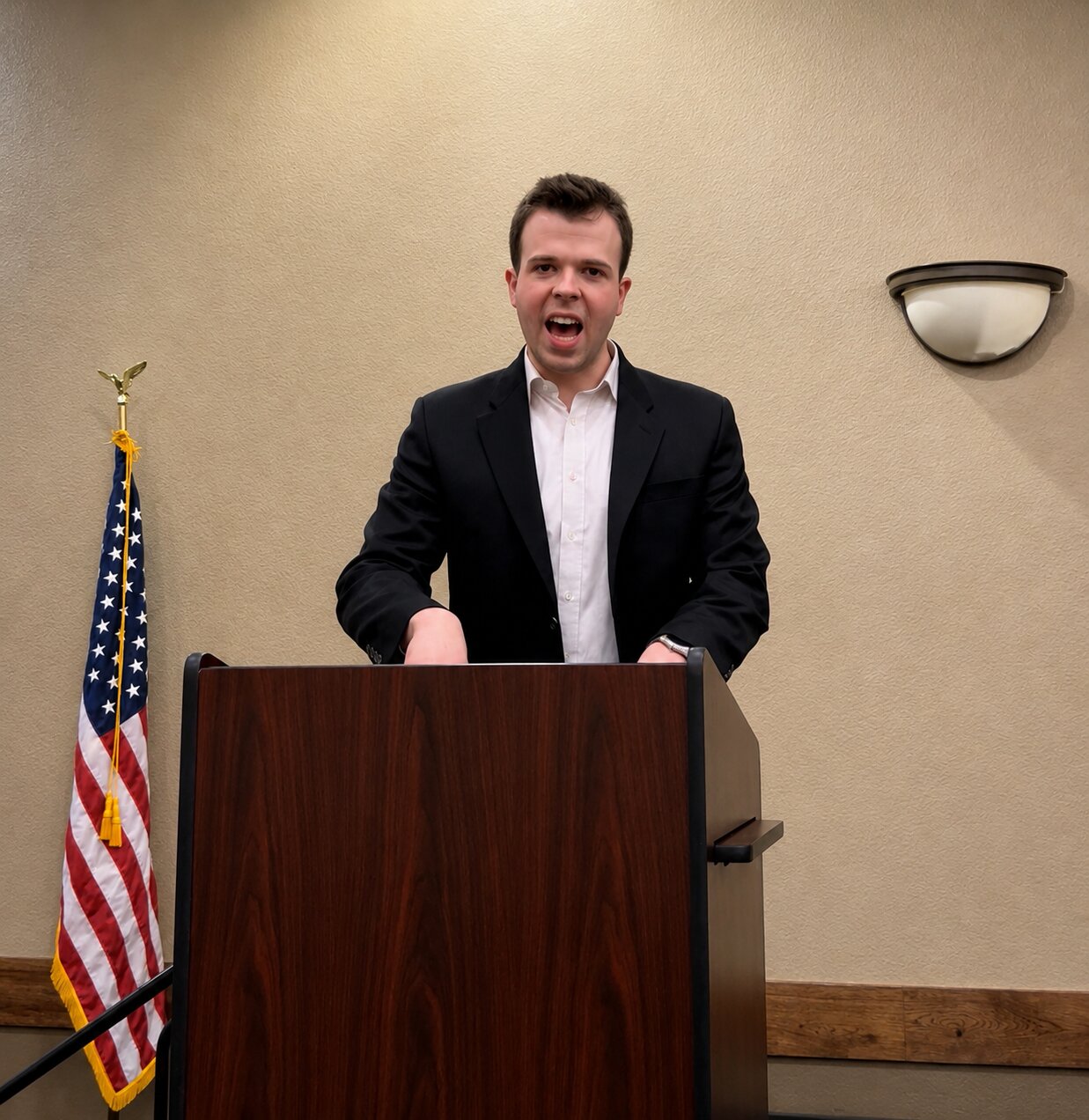 JD Hopper entrepreneur and speaker standing at a podium