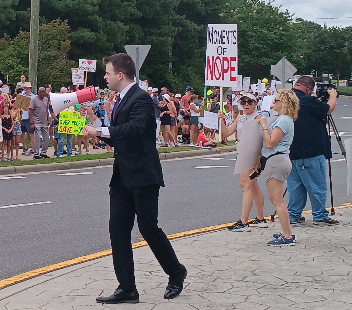 JD Hopper leading Save Morrison Coalition supporters with a megaphone in Charlotte