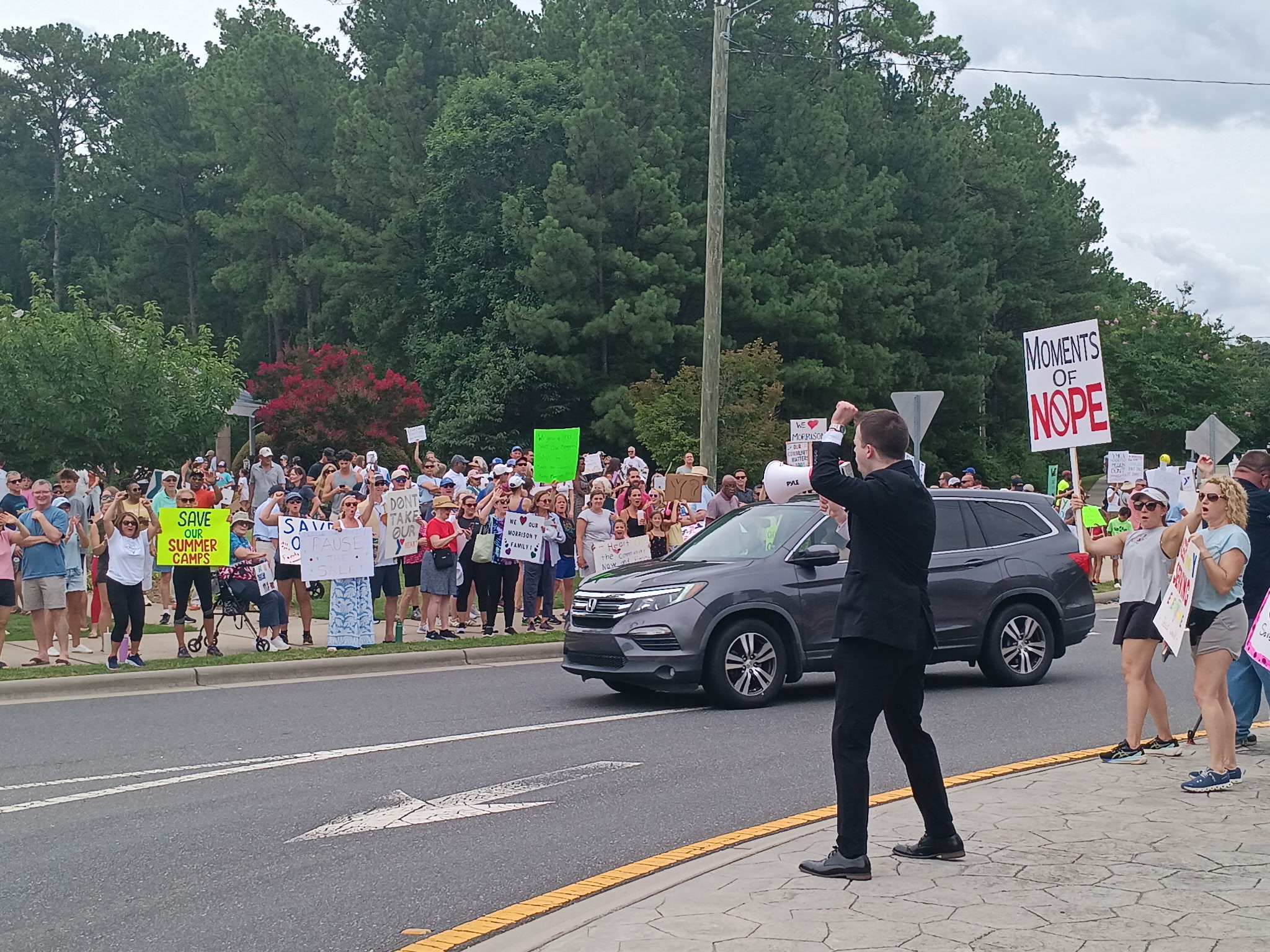 JD Hopper speaking through a megaphone to the Save Morrison rally in Charlotte