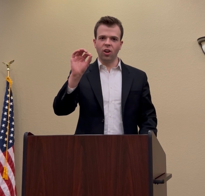JD Hopper speaking at a podium